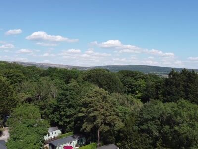 View over trees and static caravans